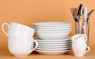 Clean white dishes on beige background