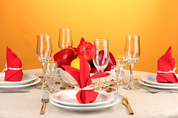 Table setting in red tones on color  background