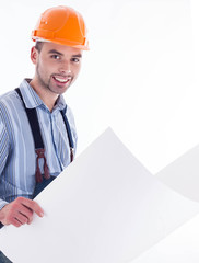 Male architect looking at blueprints against white background