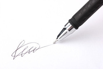 Closeup of signature (fake, not real) and pen, isolated on