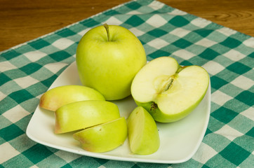 Mutsu apple slices on white plate