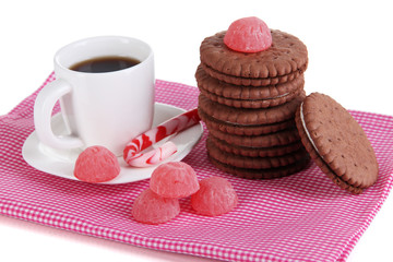 Chocolate cookies with creamy layer and cup of coffe isolated