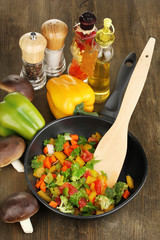 Sliced fresh vegetables in pan with spices and ingredients