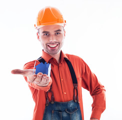 A builder man holding  a paper house.