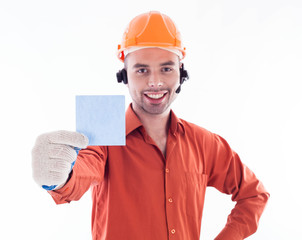 A builder man holding sheet of paper.