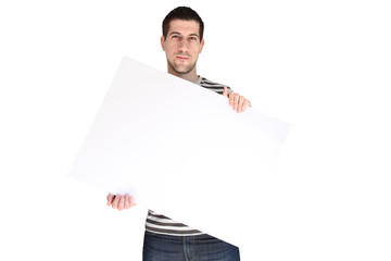 Attractive young man holding blank