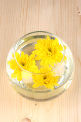 Obraz na płótnie Canvas Vase with yellow flowers on wooden background
