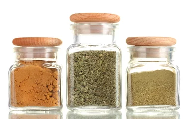 Keuken spatwand met foto powder spices in glass jars  isolated on white © Africa Studio