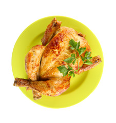 Roasted whole chicken on a green plate isolated on white