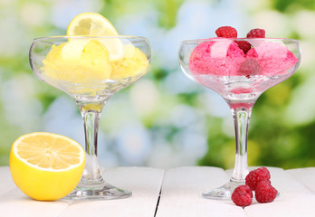 delicious ice cream on wooden table on bright background