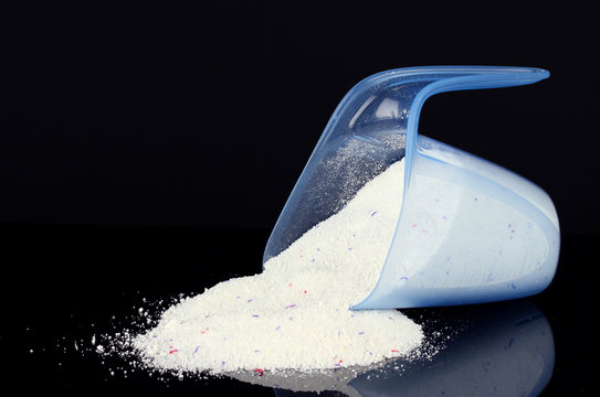 Washing Powder In A Measuring Cup, Isolated On Black