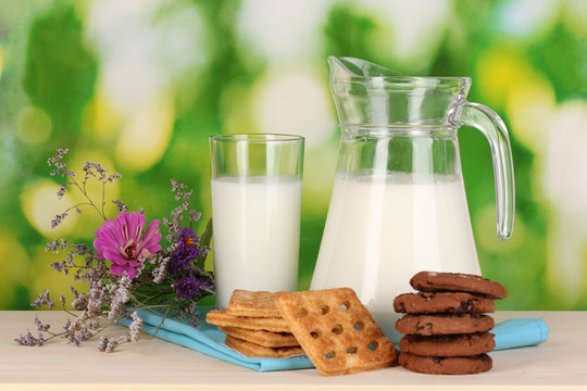 Pitcher and glass of milk with cookies