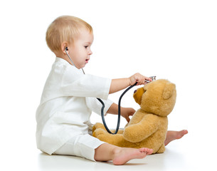 Adorable child with clothes of doctor and teddy bear over white