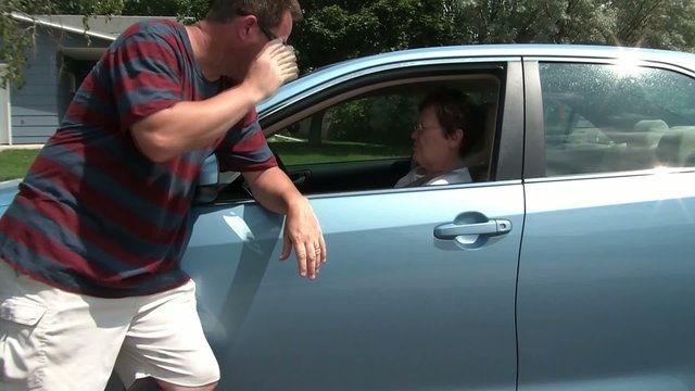 Man Talking to Woman - Leaning on Car