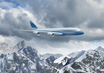Fototapeta premium White passenger plane above the mountains