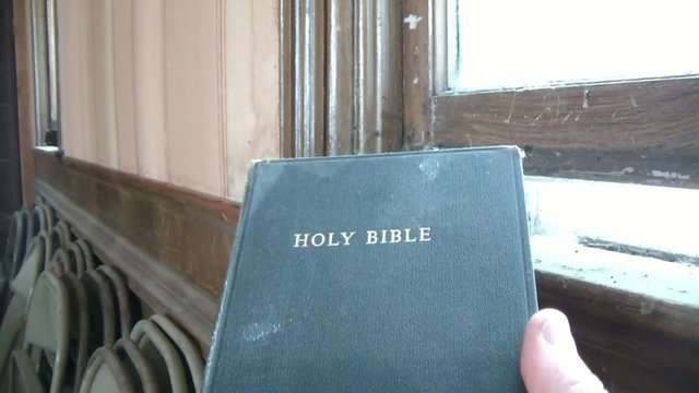 Opening Bible in Old Church