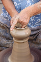 Old female hands making the traditional pottery