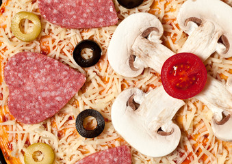 Olives, sausage, mushrooms and cheese lying on the pizza dough