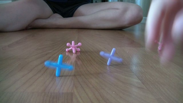 Playing Jacks with Ball on Wood