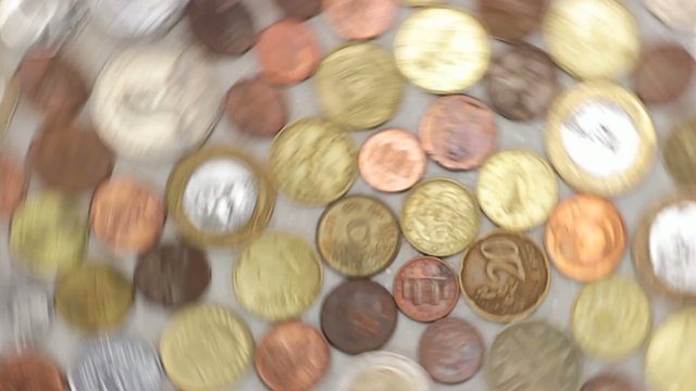 spinning coins symbolizing wealth, richness, income and profit