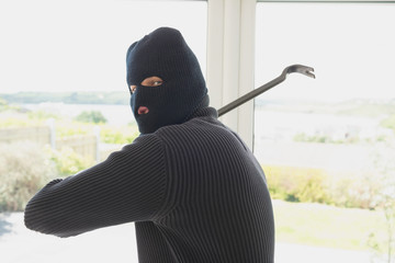 Burglar swinging crow bar