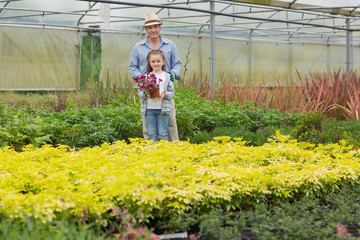 Gardener with grandchild holding purple flower