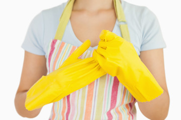 Woman taking off her rubber gloves