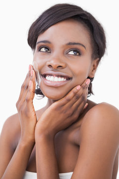 Happy Woman Putting On Face Cream