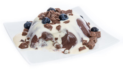 Portion of Chocolate Pudding with sauce on white