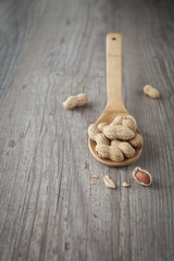 Bunch of peanuts on a wooden spoon