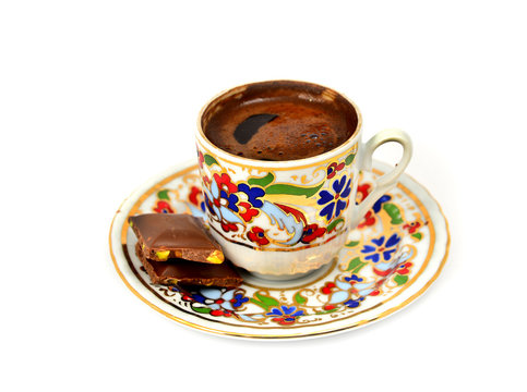 a cup of Turkish coffee with chocolate, white background