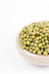 Green mung beans in bowl on white background
