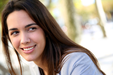 Portrait of beautiful young woman standing in the street