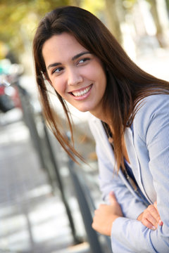 Portrait of beautiful young woman standing in the street