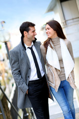 Trendy couple of lovers walking in the street