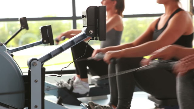 Women working out on rowing machine