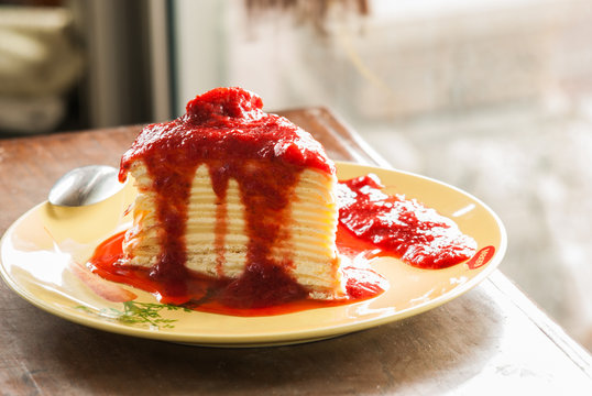 Crepe cake with strawberry sauce