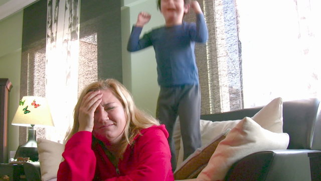 Noisy energetic little boy and tired mom