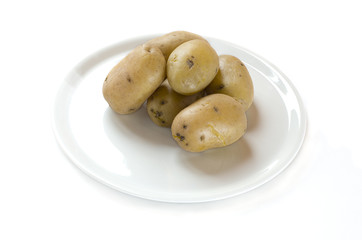 Cooked  potatoes on a plate in white background