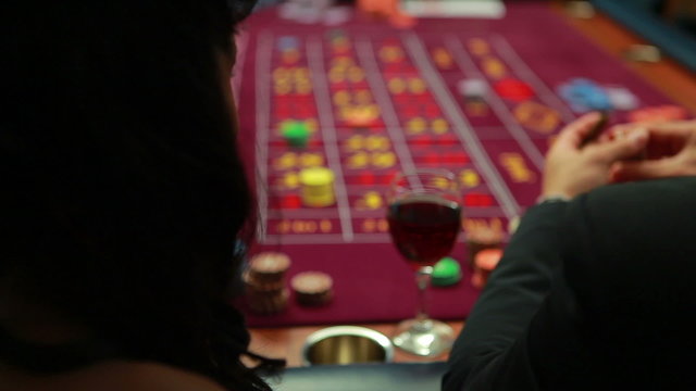 Woman talking to man while playing roulette