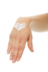 Beautiful female hand applying hand cream
