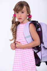 Little girl wearing backpack