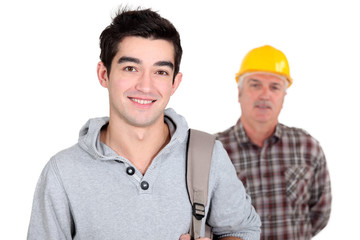 Young man standing next to an experienced worker