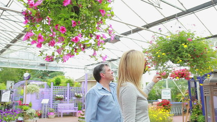 Couple looking at hanging basket - Powered by Adobe