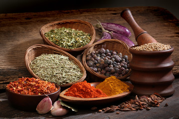 Different spices over a wood background.