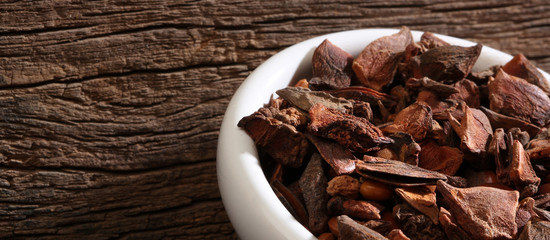 Bowl with anise over a wooden background