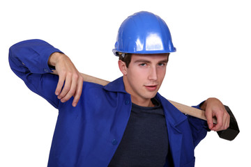 Worker carrying a piece of wood on his back