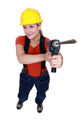 craftswoman holding a drill
