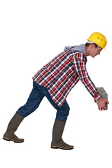 A mason posing the first stone.