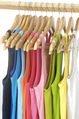 Colorful different peignoir on wooden hangers